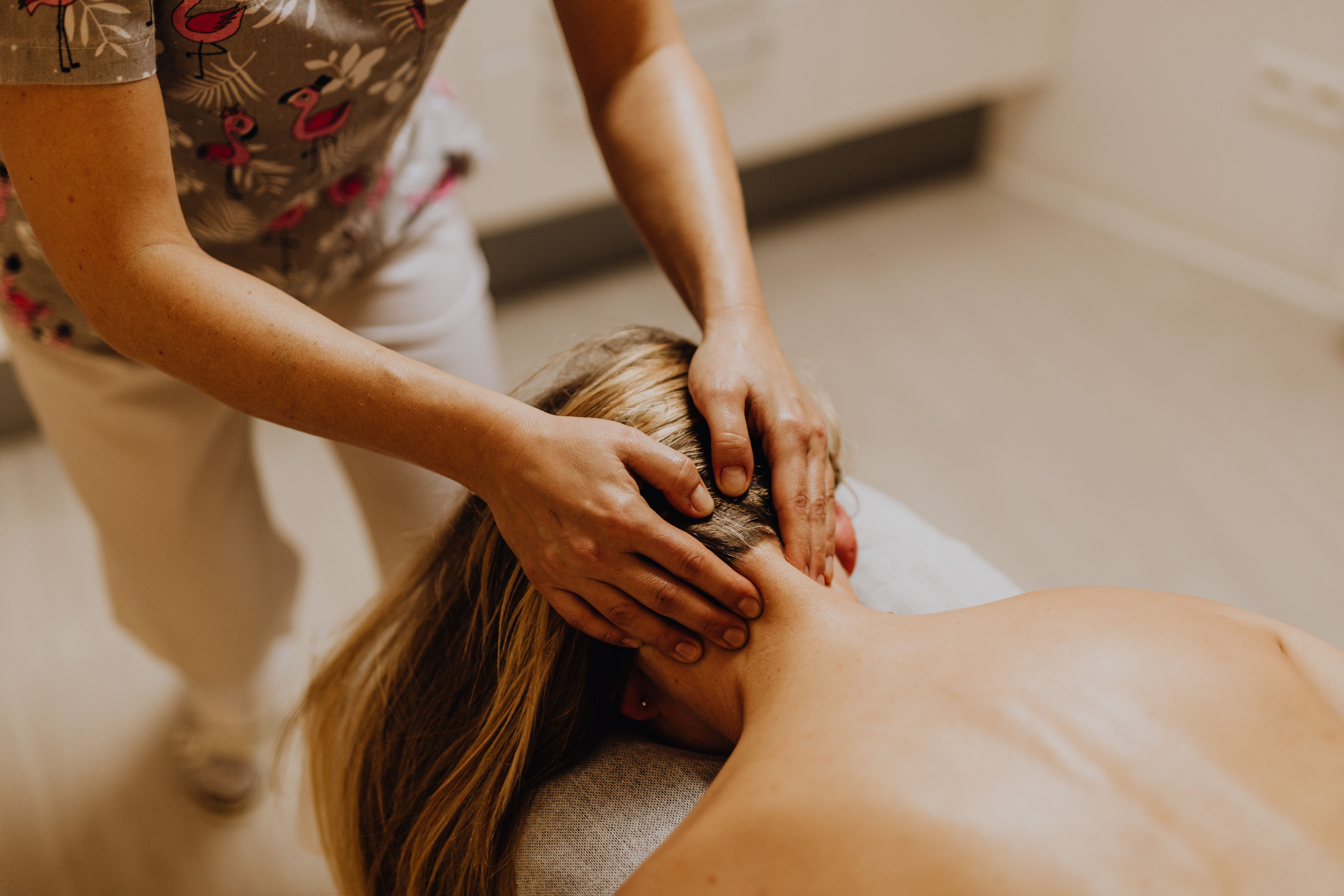 Therapist performing a scalp massage during a head spa treatment