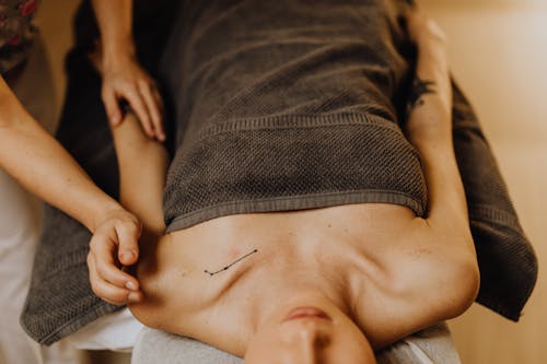 
A Tattooed Woman Having a Massage