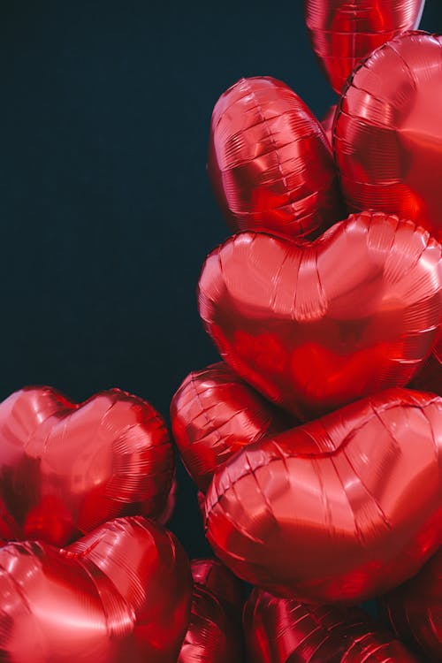 Red Heart Shaped Balloons on Black Background