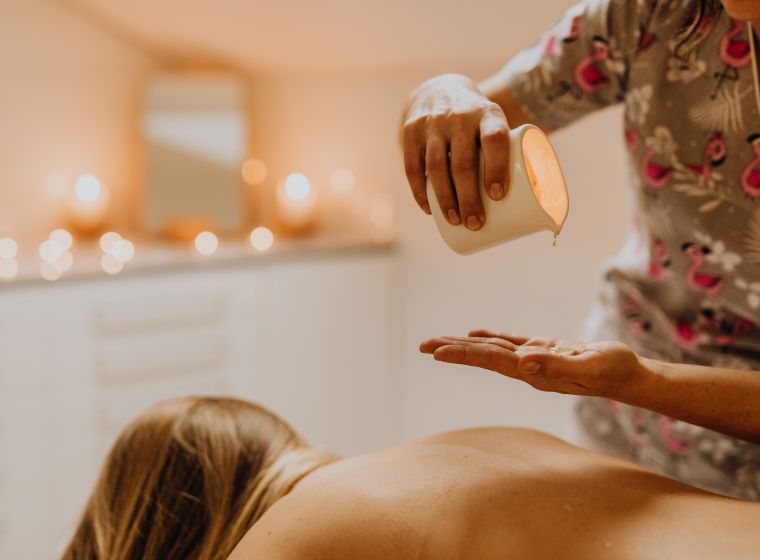 Warm oil poured by a Bagno Aurelia therapist before a massage