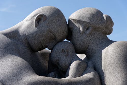 A Stone Statue of People Embracing