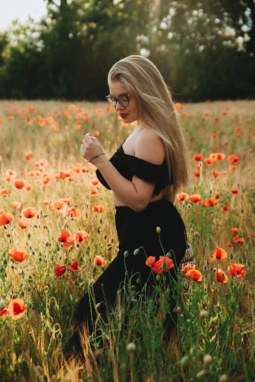 A Woman in a Black Off Shoulder Top in a Poppy Field