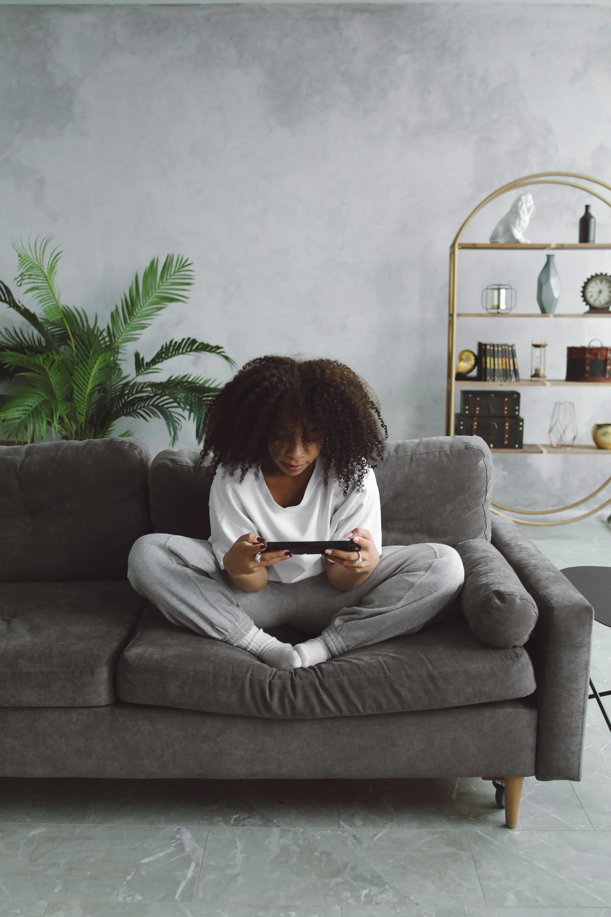 woman playin a video game on a cellphone