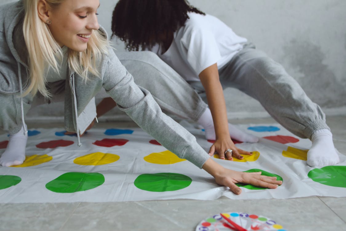 Free Women Playing a Twister Game Stock Photo