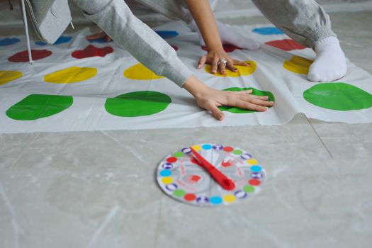 Hands on Persons on a Twister Mat