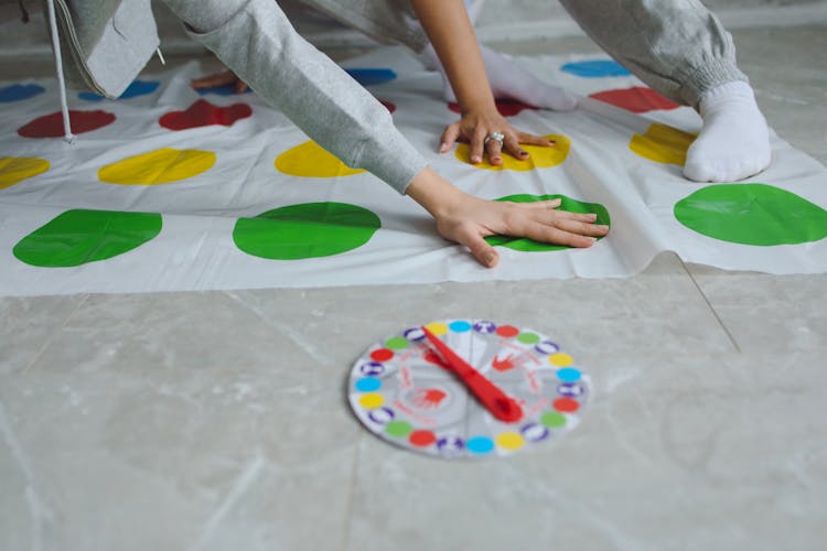 Hands On Persons On A Twister Mat