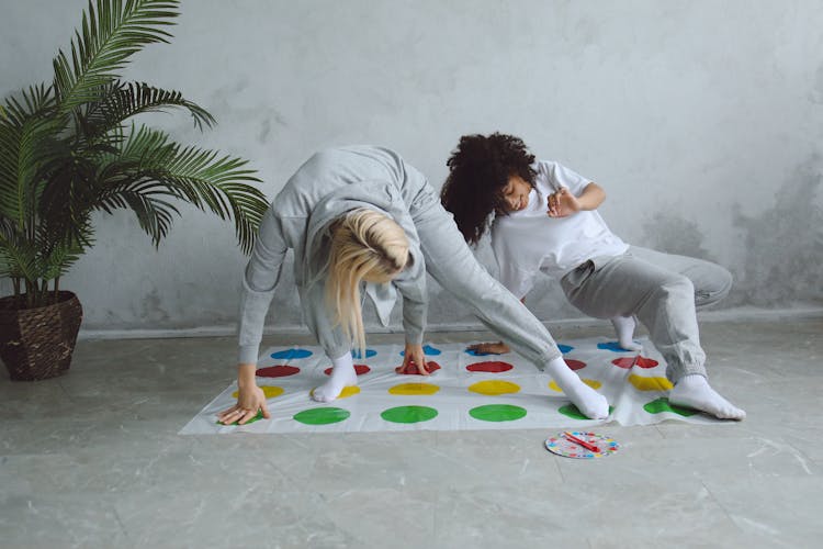 Two Women Playing A Twister Game