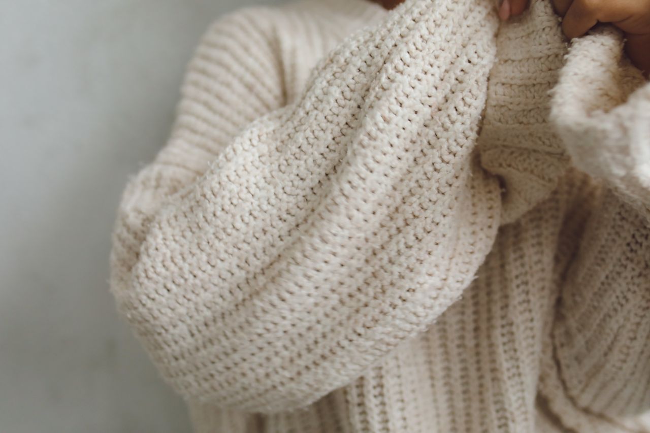 Close-up of a soft beige knitted sweater
