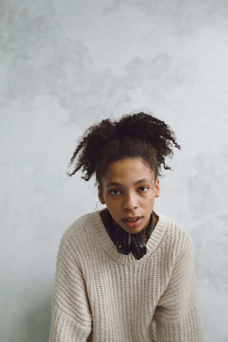 Woman with curly hair in a knitted sweater