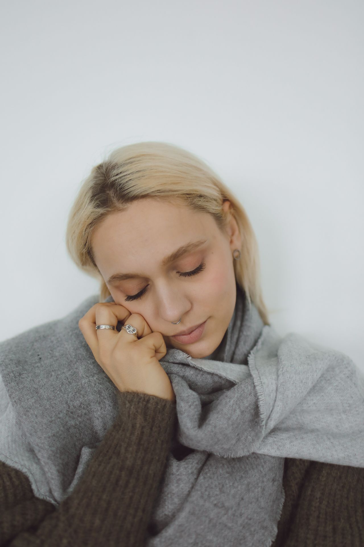 Woman wrapped in a long gray scarf