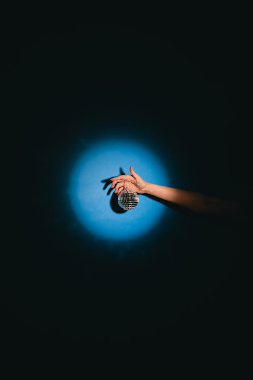 Photo of a Disco Ball Hanging from a Person's Hand
