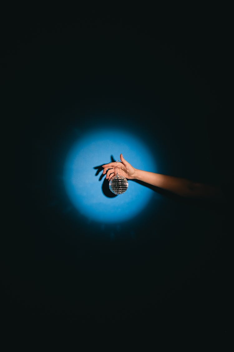 Photo Of A Disco Ball Hanging From A Person's Hand