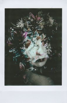 A mysterious floral double exposure of a woman's face with vintage style.