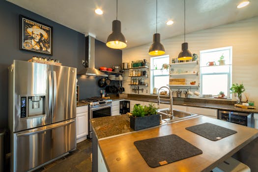 Stylish kitchen with stainless steel appliances, pendant lights, and open shelving for a contemporary look.