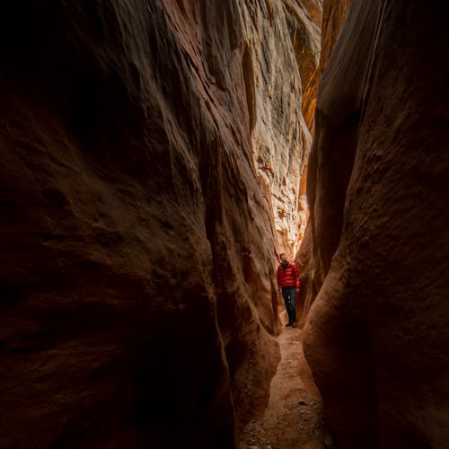 Man in Red Jacket Standing in the Crevice 