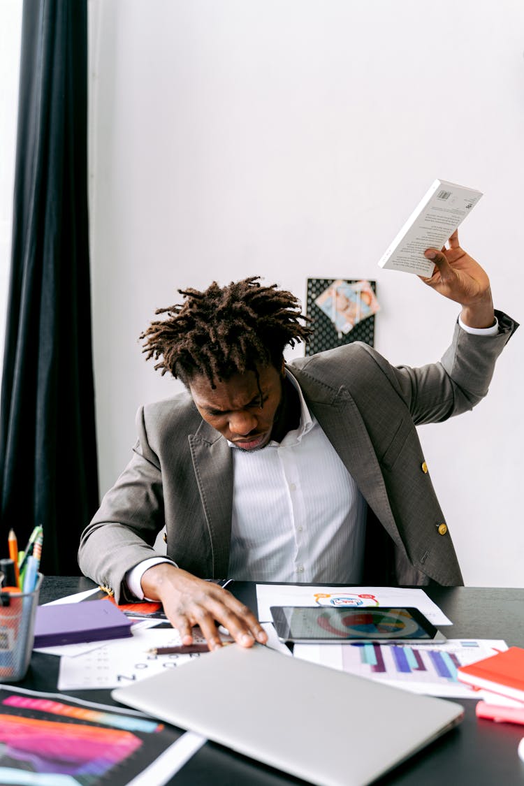 Man In Gray Suit Holding Pocket Book With Disappointment