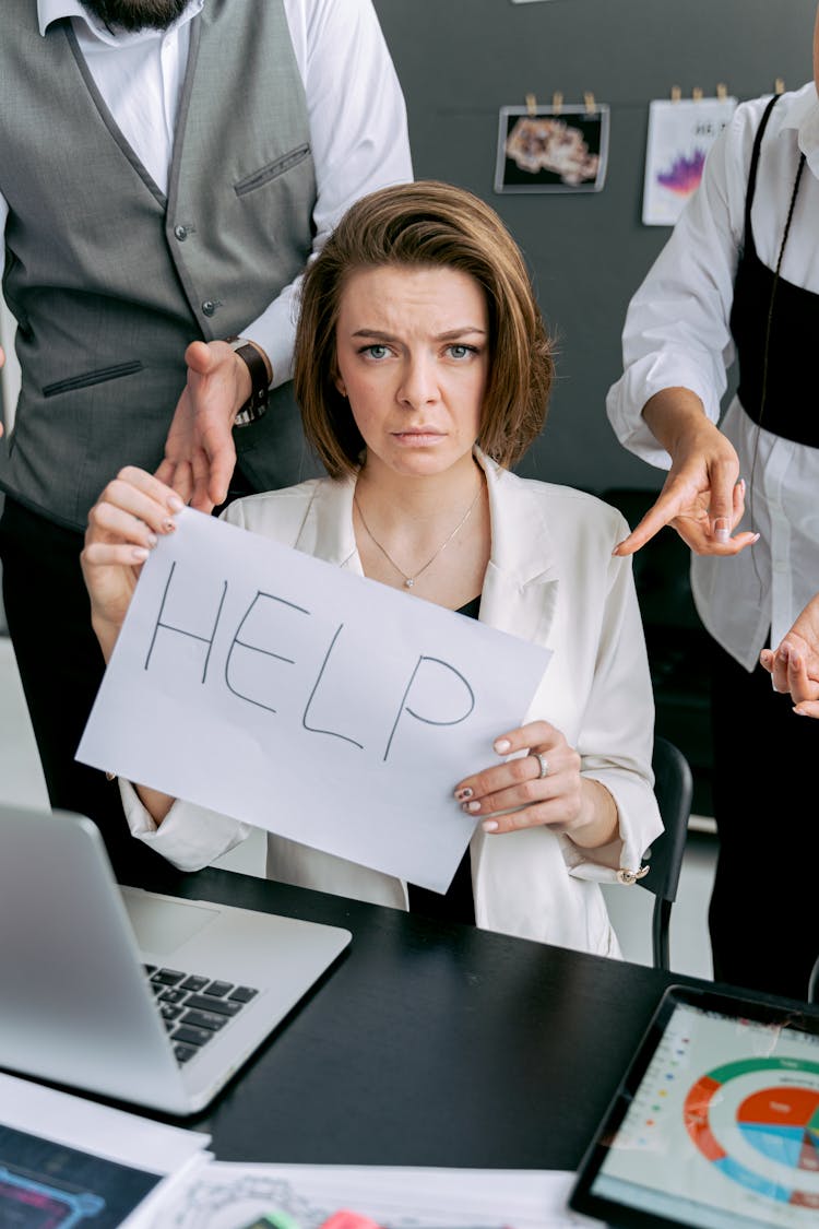 Photograph Of A Woman Holding A Paper With A Help Text