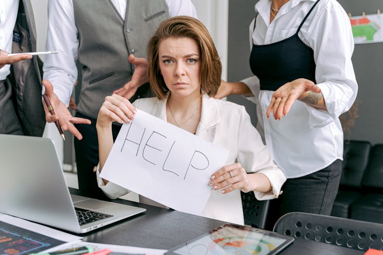 
A Woman Holding A Sign For Help