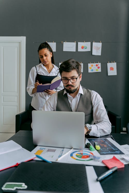Free Photo of a Woman Watching a Man with a Moustache Work Stock Photo