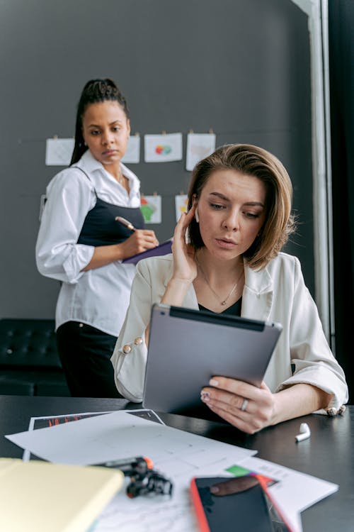 Two Women in an Office with Serious Face Expressions