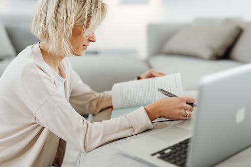 Woman with Book and Laptop