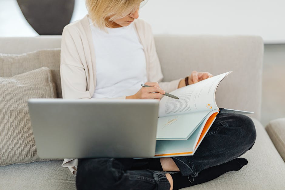 What Pet Food Labels Reveal About Protein Quality Woman sitting cross-legged on sofa, studying with a textbook and laptop, creating a cozy learning environment.