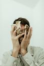 Woman in White Dress Shirt Covering Her Face With Her Hand