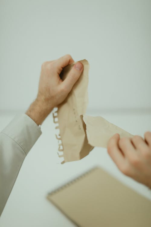 Free Person Tearing A Paper Stock Photo