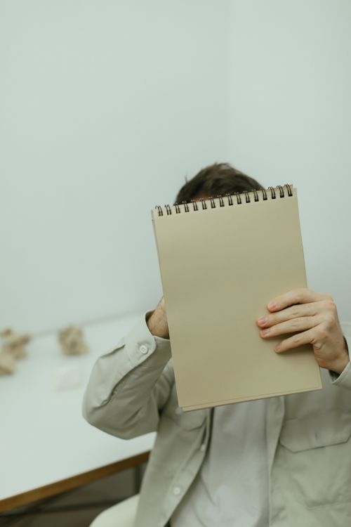 A Person Holding a Notepad · Free Stock Photo