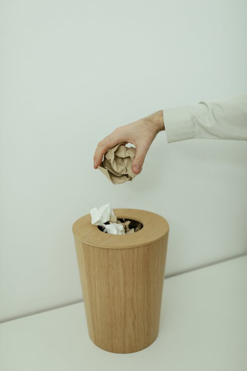 Free Person Throwing A Crumpled Paper Into A Trash Bin Stock Photo