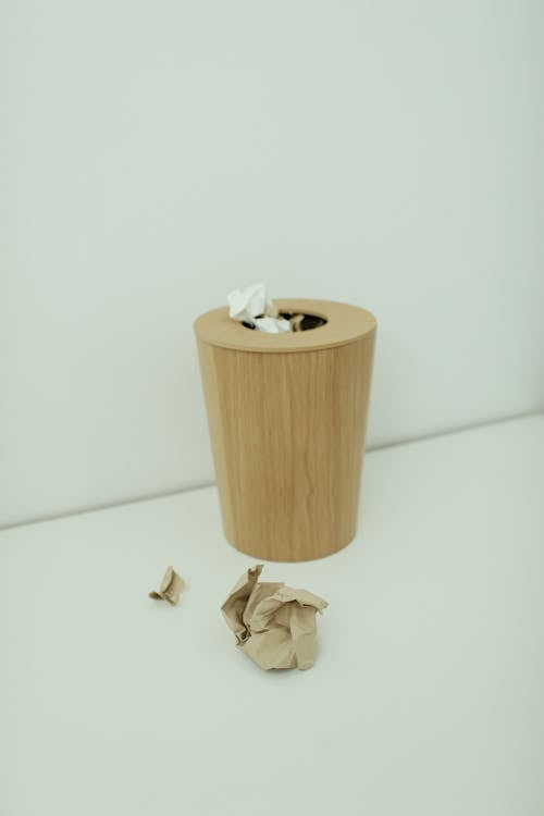 Brown Wooden Trash Bin With Crumpled Papers