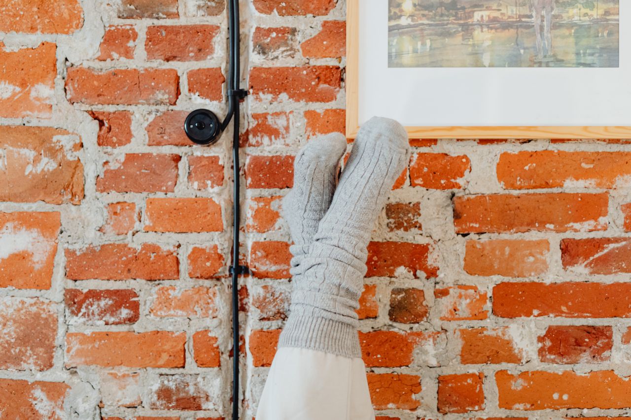 plain gray everyday socks against a rustic brick wall
