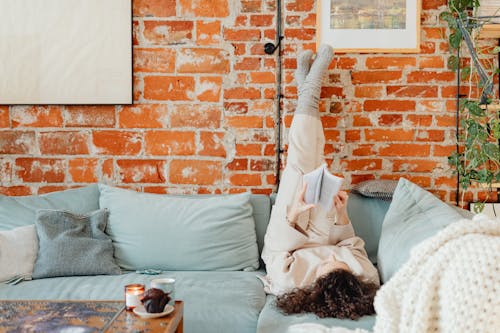 Woman Lying with Feet Against the Wall