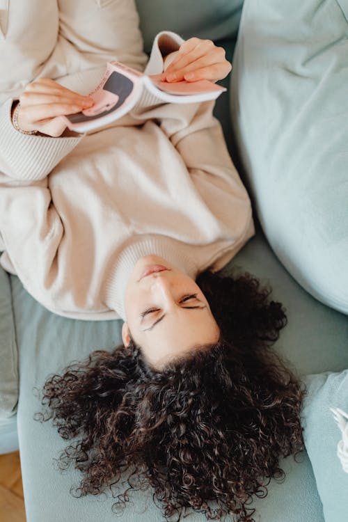 Woman Wearing Sweater Lying on Sofa