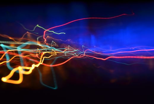 Colorful neon light streaks creating an abstract, dynamic visual effect.
