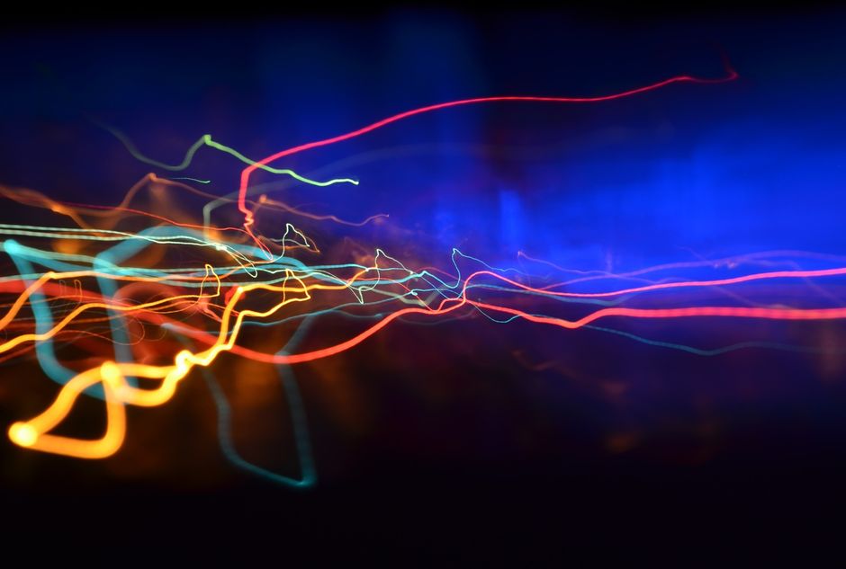 Colorful neon light streaks creating an abstract, dynamic visual effect.