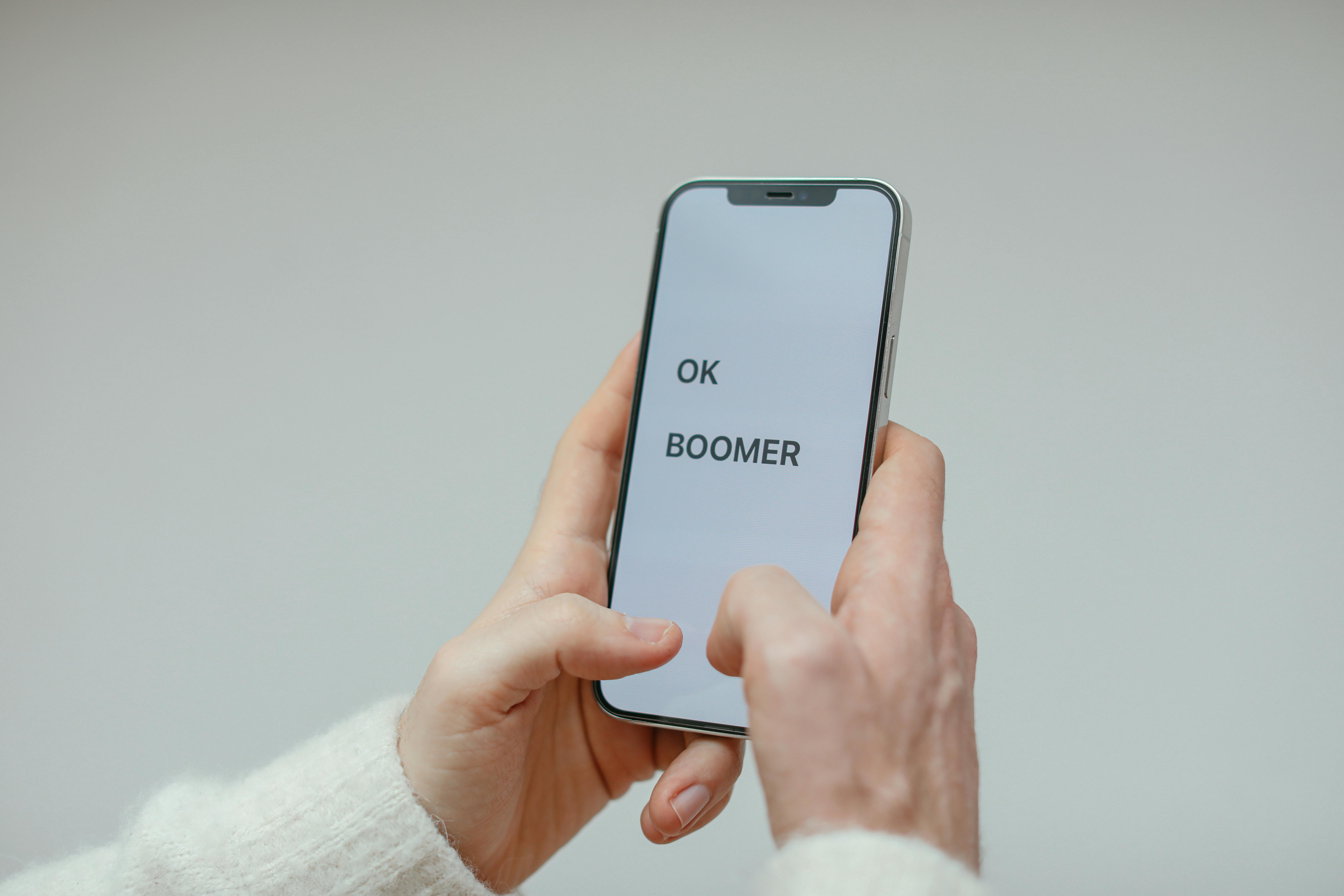 a person in white sweater holding a cellphone with message