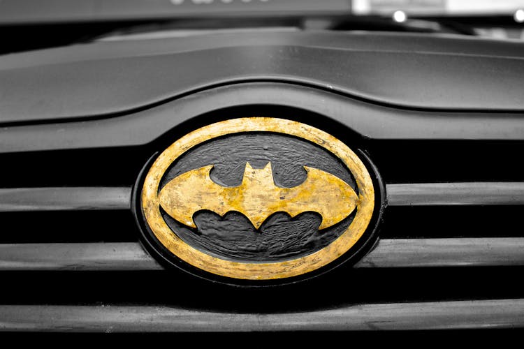 Black And Brown Batman Emblem Close-up Photography