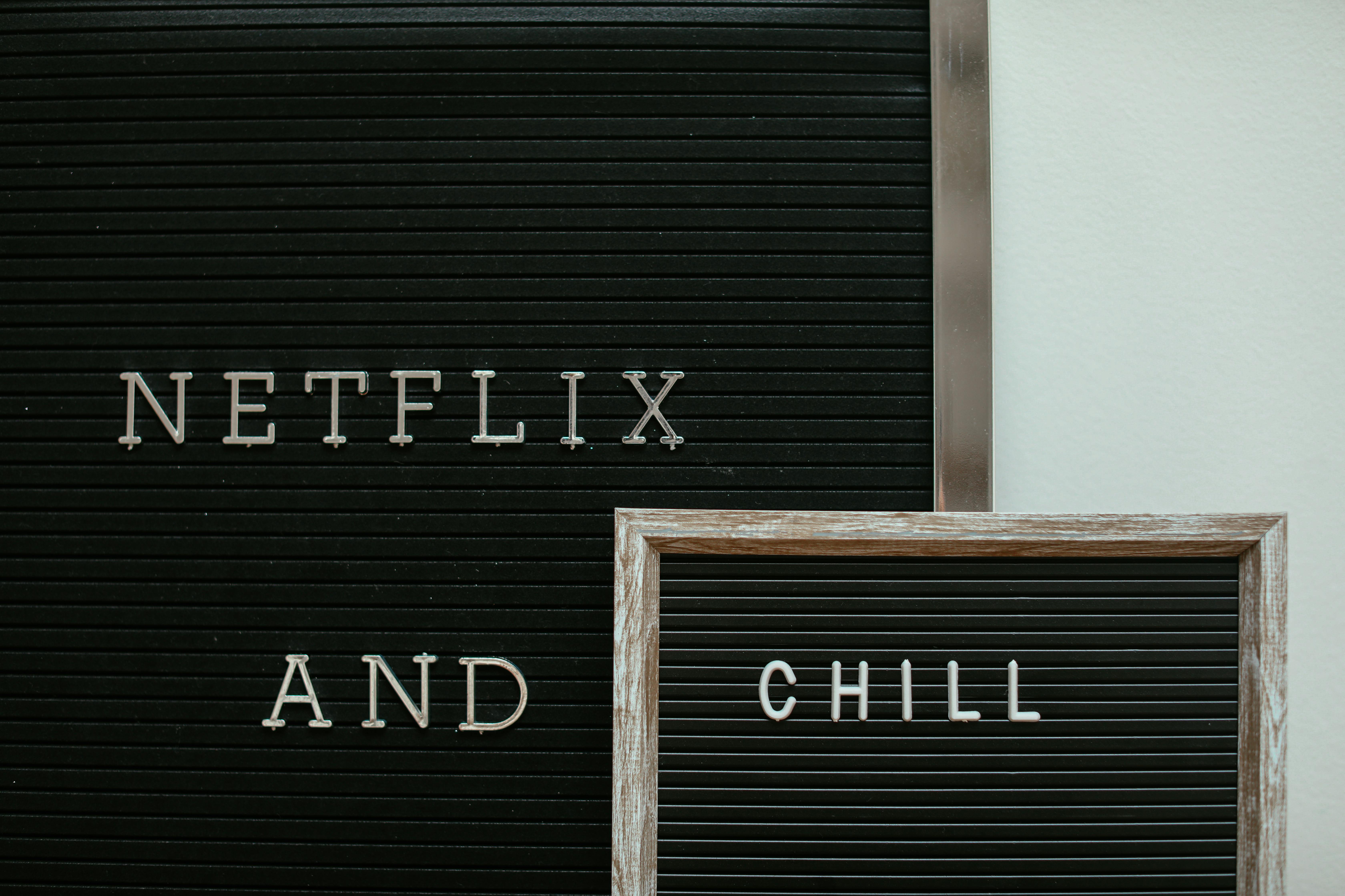 A letter board with the phrase 'Netflix and Chill' displayed in a minimalist style.