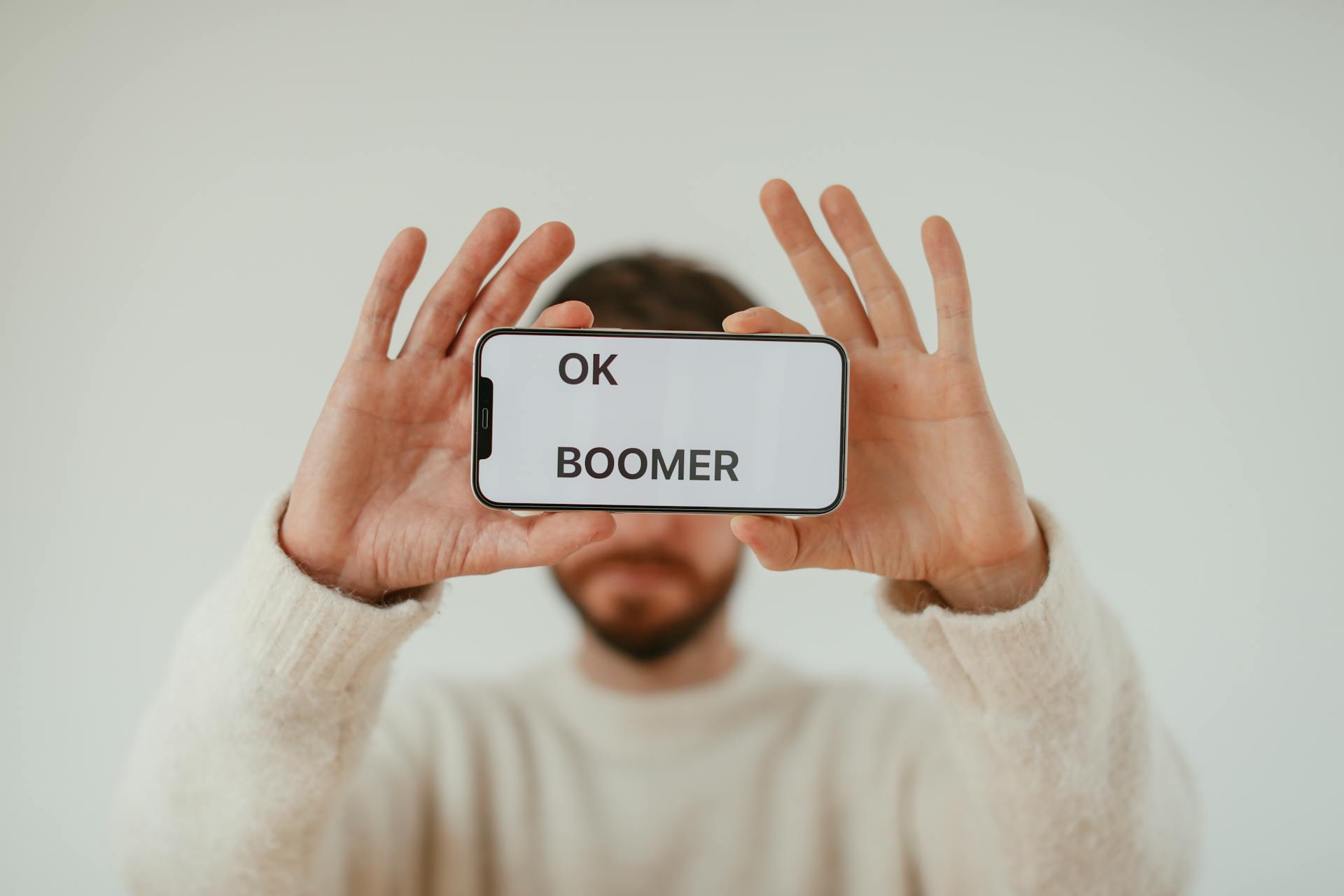 Man Holding Smartphone with Phrase on Screen