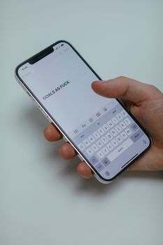 Close-up of a hand holding a smartphone displaying a motivational message, emphasizing goals. — photo by Cup of  Couple