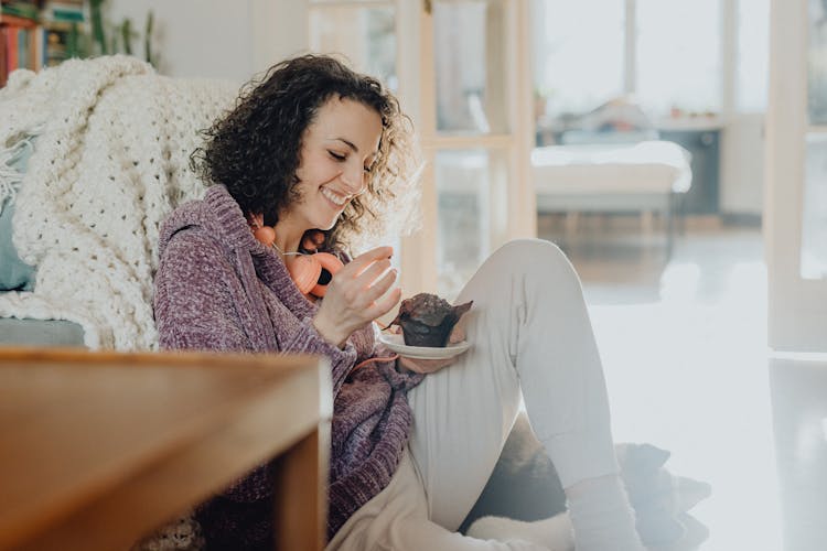 Woman Eating A Cake At Home