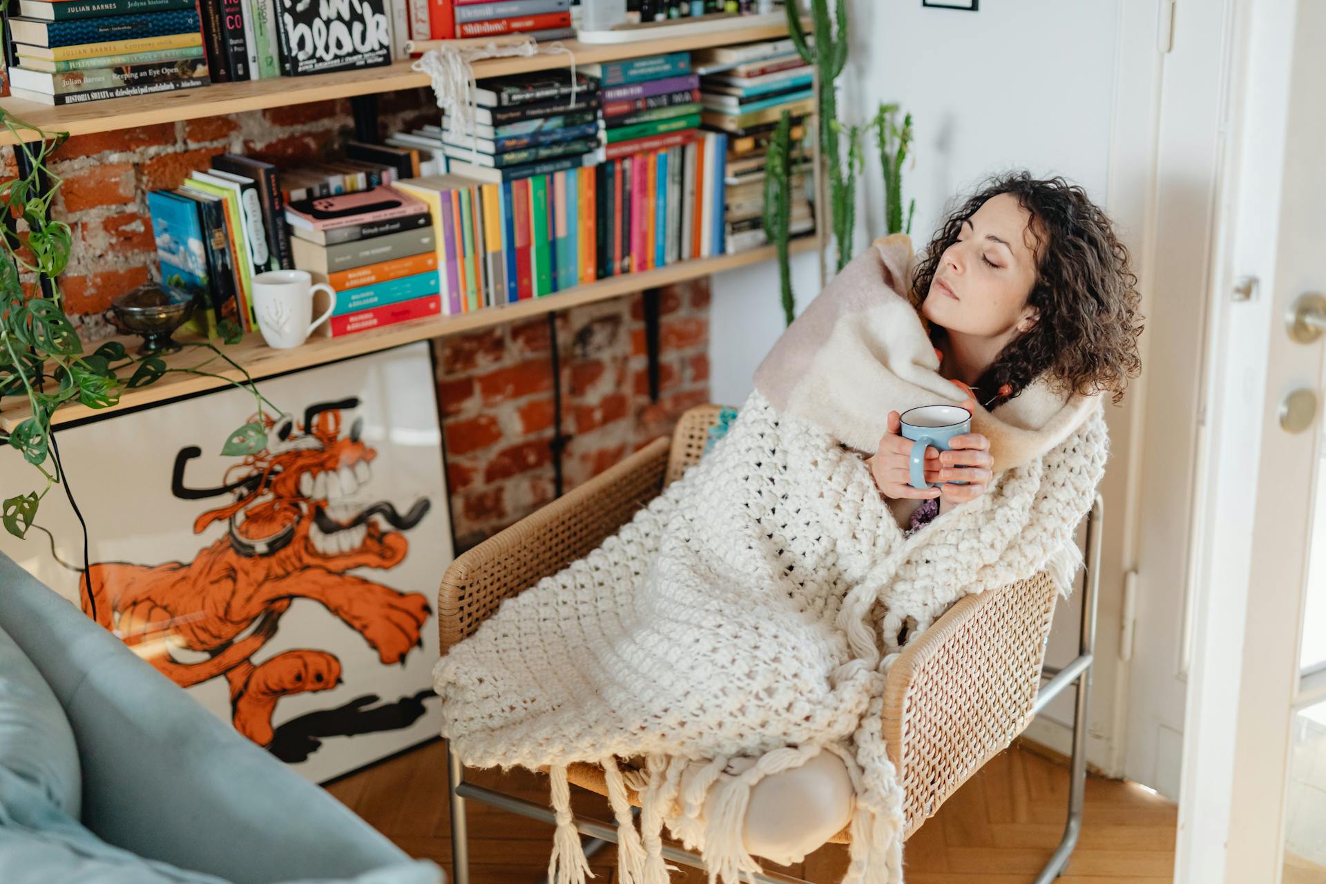 Woman Feeling Cold Wrapped in a Shawl and Drinking Tea