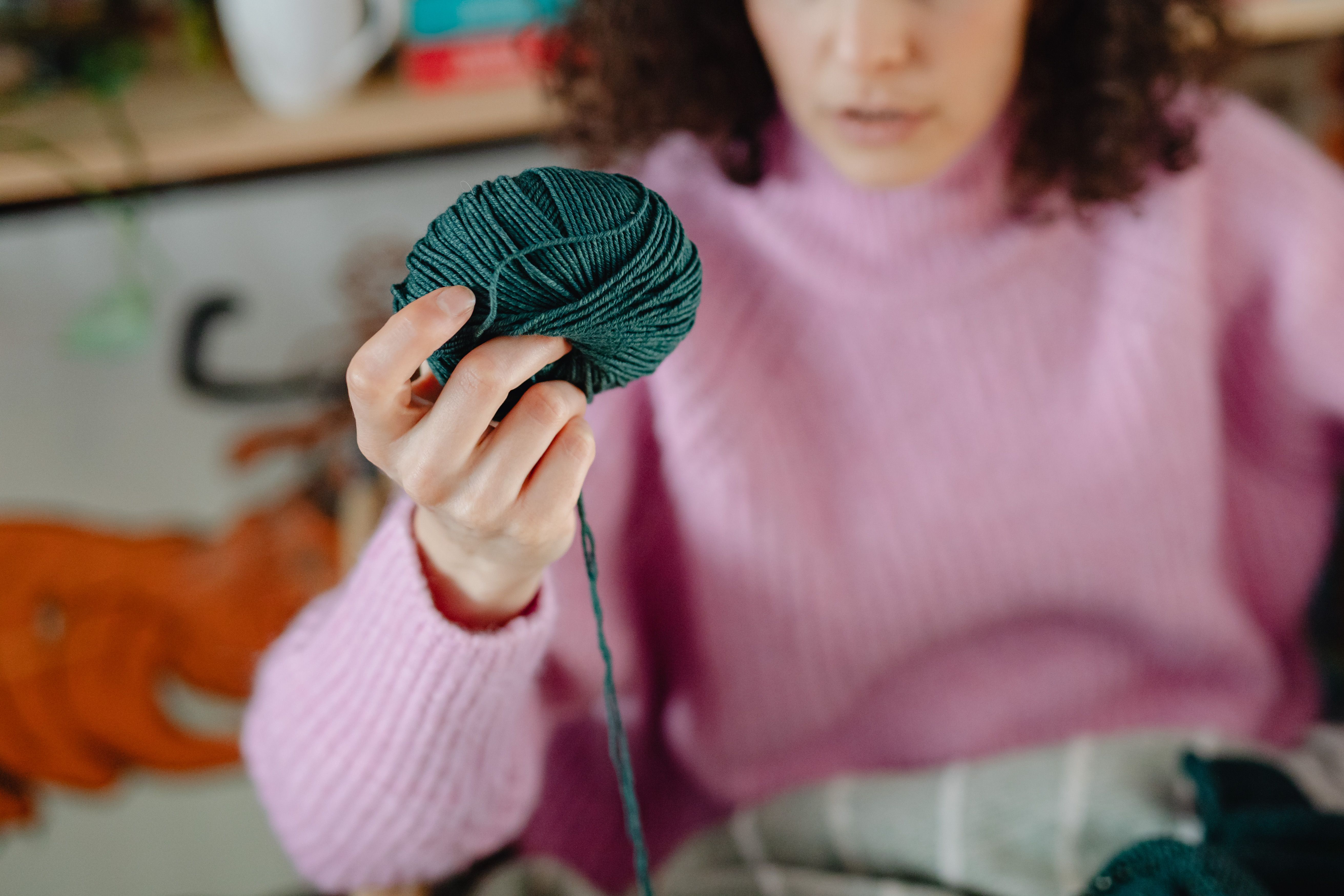 Person Holding Brown Yarn Roll · Free Stock Photo