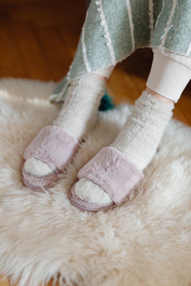 Close Up Of Woman Feet In Warm Socks And Slippers