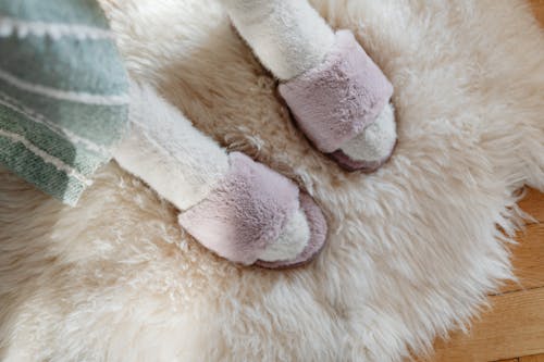 Close-up of a Woman Wearing Fluffy Socks and Slippers 