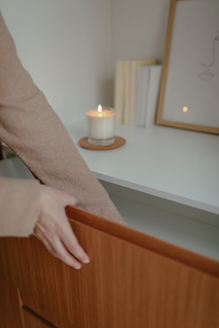 Arms Of A Woman Opening A Drawer