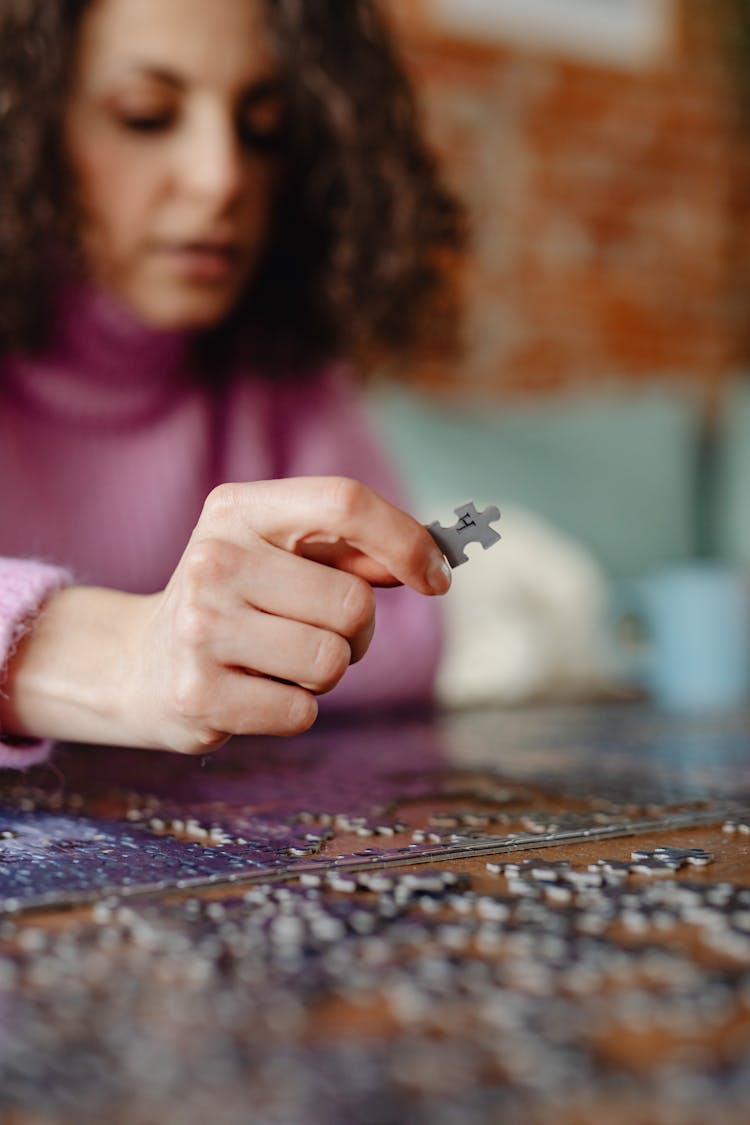 A Person Holding A Puzzle Piece