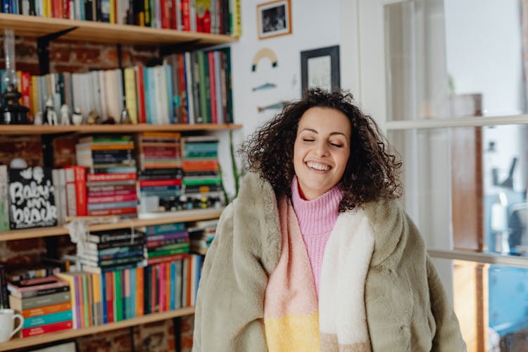 Woman In Comfortable Clothes By Bookshelves