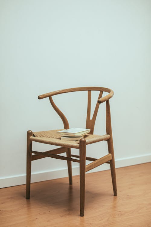 Free Close-Up Shot of Books on a Wooden Chair Stock Photo